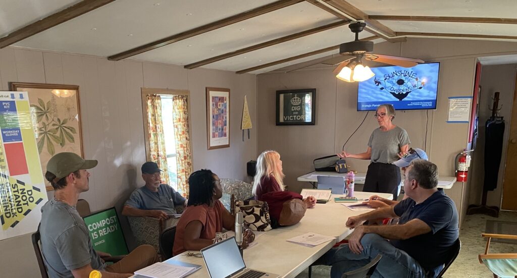 a photo of the board and guests listening to a strategic plannnig presentation