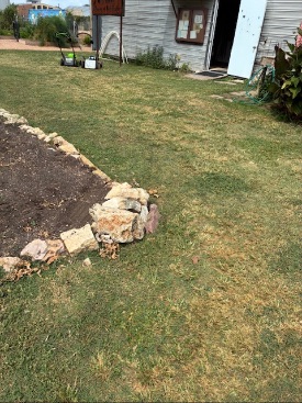 tire tracks across the corner of a garden