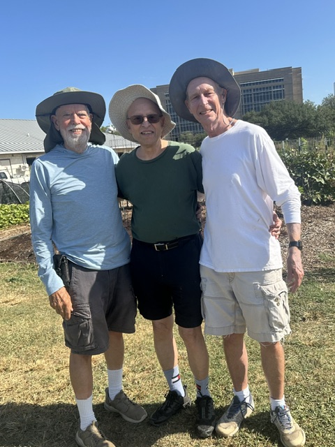photo of three men wearing similar floppy hats